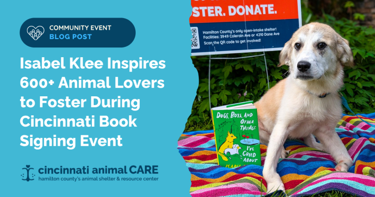 foster dog alani posing with isabel klee book before book signing event in cincinnati
